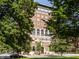 Exterior shot of brick building framed by lush green trees at 350 N Meridian St # 606/607, Indianapolis, IN 46204