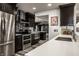 Well-equipped kitchen featuring stainless steel appliances and dark cabinets with long countertop at 350 N Meridian St # 606/607, Indianapolis, IN 46204