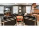 A stylish living room featuring four black leather chairs and unique orange ottoman at 350 N Meridian St # 606/607, Indianapolis, IN 46204