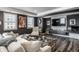 Modern living room with dark walls, plank floors, white sofa, and a large television with stone surround at 350 N Meridian St # 606/607, Indianapolis, IN 46204