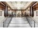 Elegant lobby showcasing marble stairs, ornate woodworking, and a sparkling chandelier at 350 N Meridian St # 606/607, Indianapolis, IN 46204