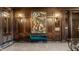 Ornate lobby featuring dark wood accents, sconce lighting, artwork, and a comfortable settee at 350 N Meridian St # 606/607, Indianapolis, IN 46204