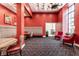 Inviting lounge area showcasing stylish seating, vibrant red walls, and elegant chandelier lighting at 350 N Meridian St # 606/607, Indianapolis, IN 46204
