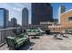 Open roof deck with stylish furniture, barbecue grill, and expansive city views at 350 N Meridian St # 606/607, Indianapolis, IN 46204