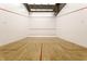 Indoor squash court with hardwood floor, painted lines, and blank white walls at 350 N Meridian St # 606/607, Indianapolis, IN 46204
