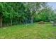 Spacious backyard with a swing set and green grass at 3513 Ireland Dr, Indianapolis, IN 46235