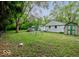 Backyard with a swing set, white house, and shed at 3513 Ireland Dr, Indianapolis, IN 46235