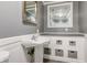 Bathroom featuring a pedestal sink with storage and framed mirrors at 3513 Ireland Dr, Indianapolis, IN 46235
