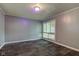 Modest bedroom with gray walls and carpet getting light from a large window at 3513 Ireland Dr, Indianapolis, IN 46235