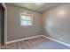 Small, cozy bedroom with gray walls and carpet, and natural light from one window at 3513 Ireland Dr, Indianapolis, IN 46235