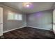 Simple bedroom with gray walls, mixed color carpet, and natural light from the window at 3513 Ireland Dr, Indianapolis, IN 46235
