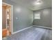 Bedroom with light gray walls, neutral carpet, and hardwood hallway at 3513 Ireland Dr, Indianapolis, IN 46235