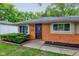 Charming single-story brick home with a dark front door flanked by two windows and tidy landscaping at 3513 Ireland Dr, Indianapolis, IN 46235