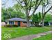 Charming single-story home with a brick facade and a well-maintained lawn, framed by mature trees at 3513 Ireland Dr, Indianapolis, IN 46235