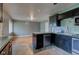 Bright kitchen featuring sleek black cabinetry, modern appliances, and stylish tile flooring at 3513 Ireland Dr, Indianapolis, IN 46235