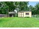 Well-maintained backyard shed and tree house, providing ample storage and play space within a large yard at 3515 Lindenwald Dr, Indianapolis, IN 46217