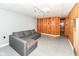 A finished basement space with a sectional sofa and wood paneling accent at 3515 Lindenwald Dr, Indianapolis, IN 46217