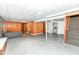 Spacious basement featuring concrete floors, paneled walls, and ample open space for various activities at 3515 Lindenwald Dr, Indianapolis, IN 46217