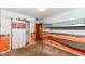 A bedroom with a bunk bed, an orange accent wall and floral decorated walls at 3515 Lindenwald Dr, Indianapolis, IN 46217