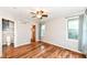 Light-filled bedroom features wood floors, a closet, and two large windows overlooking a garden at 3515 Lindenwald Dr, Indianapolis, IN 46217
