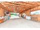 Large unfinished garage featuring natural wood framing, offering ample space for vehicles, and workshop area at 3515 Lindenwald Dr, Indianapolis, IN 46217
