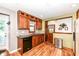 The kitchen includes dark cabinets, black appliances, mosaic backsplash, and wood-look floors at 3515 Lindenwald Dr, Indianapolis, IN 46217