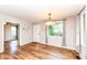 Bright living room featuring wood floors, modern lighting, and a view to the front yard at 3515 Lindenwald Dr, Indianapolis, IN 46217