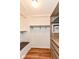 Spacious walk-in closet with built-in shelves, hanging rods, and hardwood floors at 3515 Lindenwald Dr, Indianapolis, IN 46217