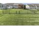 Fenced-in backyard with a wooden deck and green grass at 3962 Kristi Way, Greenwood, IN 46142
