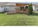 Backyard featuring a wooden deck, patio, and flowerbed at 3962 Kristi Way, Greenwood, IN 46142