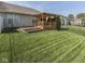 Backyard featuring a wooden deck, flowerbed, and green grass at 3962 Kristi Way, Greenwood, IN 46142