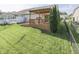 Backyard featuring a flowerbed, a tall evergreen tree, and green grass at 3962 Kristi Way, Greenwood, IN 46142