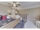 Bedroom with a ceiling fan, accent chair, and railing at 3962 Kristi Way, Greenwood, IN 46142