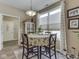 Bright dining area features a round table with seating for four and a large window at 3962 Kristi Way, Greenwood, IN 46142