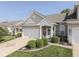 Home exterior with a brick facade, attached garage, and landscaped lawn, blending curb appeal and functionality at 3962 Kristi Way, Greenwood, IN 46142