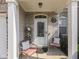 Inviting front porch with seating, a decorative door, and brick accents, offering a warm welcome at 3962 Kristi Way, Greenwood, IN 46142