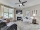 Bright living room features a fireplace, large windows, and comfortable seating at 3962 Kristi Way, Greenwood, IN 46142