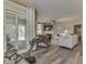 Spacious living room with hardwood floors, white couches, fireplace, and access to the outdoor patio at 3962 Kristi Way, Greenwood, IN 46142