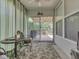 Bright sunroom with a view of the deck and lush greenery, with a ceiling fan at 3962 Kristi Way, Greenwood, IN 46142