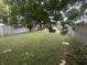 Lush backyard with mature trees, a well-kept lawn and a wooden fence at 4130 Rookwood Ave, Indianapolis, IN 46208