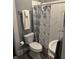 Bathroom featuring toilet, stand up shower with decorative curtain and a pedestal sink at 4130 Rookwood Ave, Indianapolis, IN 46208