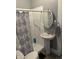 Bathroom with a stand up shower, pedestal sink, and decorative shower curtain at 4130 Rookwood Ave, Indianapolis, IN 46208