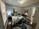 Bright bedroom featuring wood floors, serene decor, and a view into the hallway at 4130 Rookwood Ave, Indianapolis, IN 46208