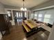 Open-concept dining area with a large wooden table, seating, and bright windows at 4130 Rookwood Ave, Indianapolis, IN 46208