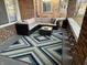 Inviting porch featuring comfortable wicker furniture and a vibrant geometric rug at 4130 Rookwood Ave, Indianapolis, IN 46208
