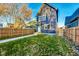 Well-kept backyard with a green lawn, wooden fence, and a clear view of the home's exterior at 430 N Keystone Ave, Indianapolis, IN 46201
