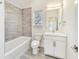 Stylish bathroom featuring modern fixtures and tile surround, with a vanity and a bright window at 430 N Keystone Ave, Indianapolis, IN 46201
