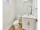Charming powder room with white vanity, modern fixtures, and a stylish mirror reflecting the entryway at 430 N Keystone Ave, Indianapolis, IN 46201