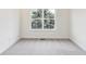 A cozy bedroom featuring a large window that looks out onto lush trees at 430 N Keystone Ave, Indianapolis, IN 46201