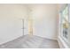 Bright bedroom featuring neutral carpeting, white walls, and a big window for lots of natural light at 430 N Keystone Ave, Indianapolis, IN 46201